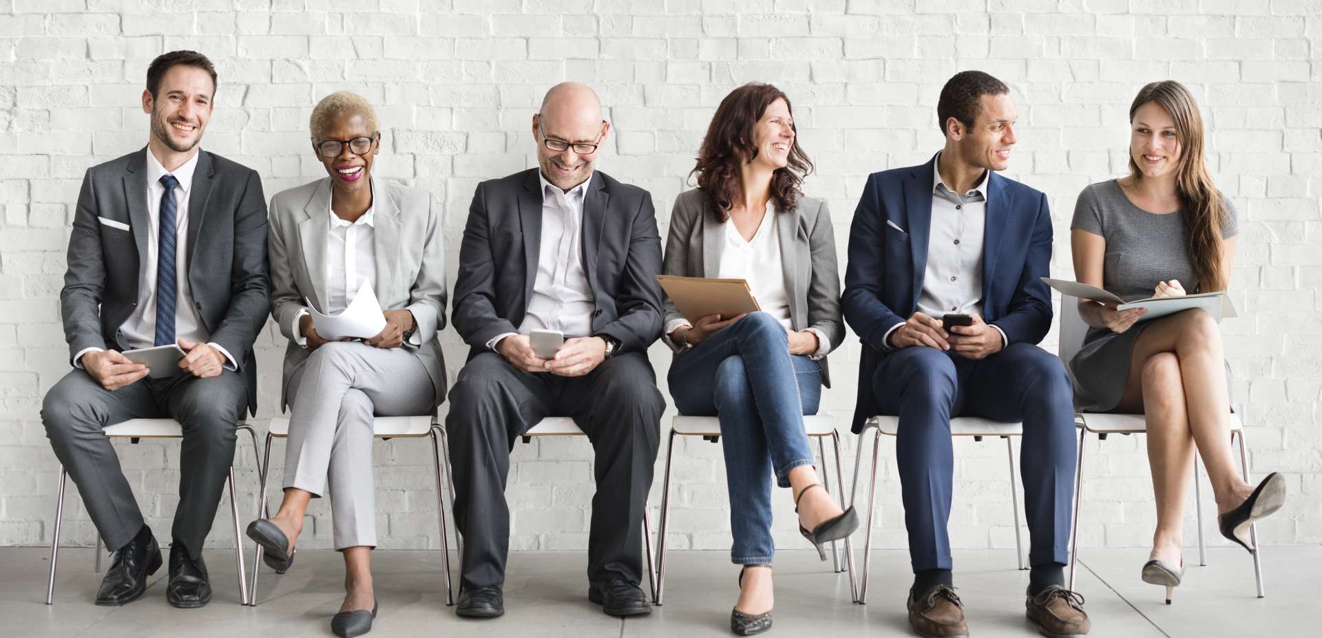 group of diverse men and women are waiting for a job interview
