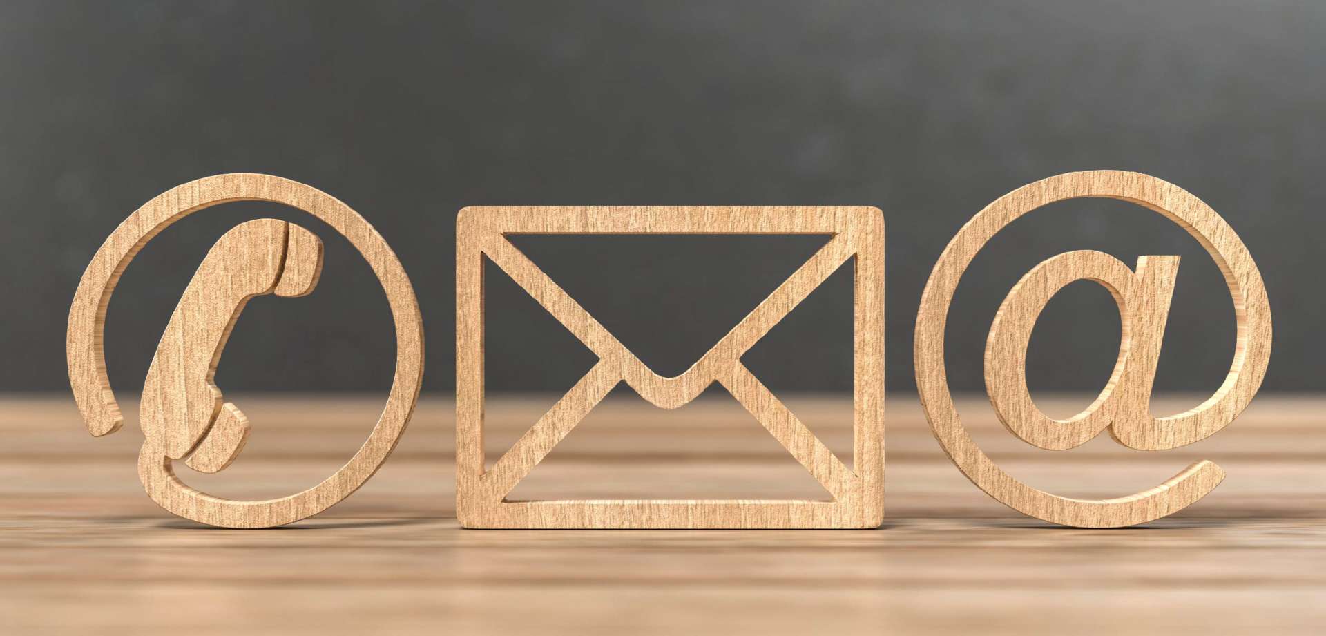 Wooden 3D rendered icons of phone, email sign and, @ sign