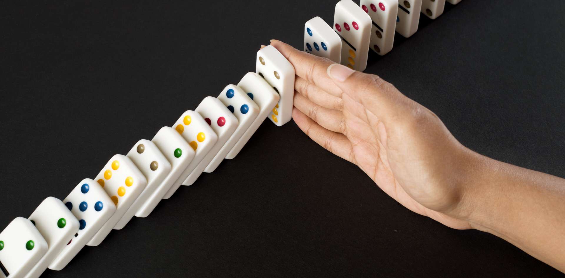 Hand stopping domino effect